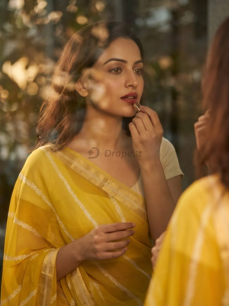 Saree marketing creative — model in a yellow chiffon saree in golden-hour light